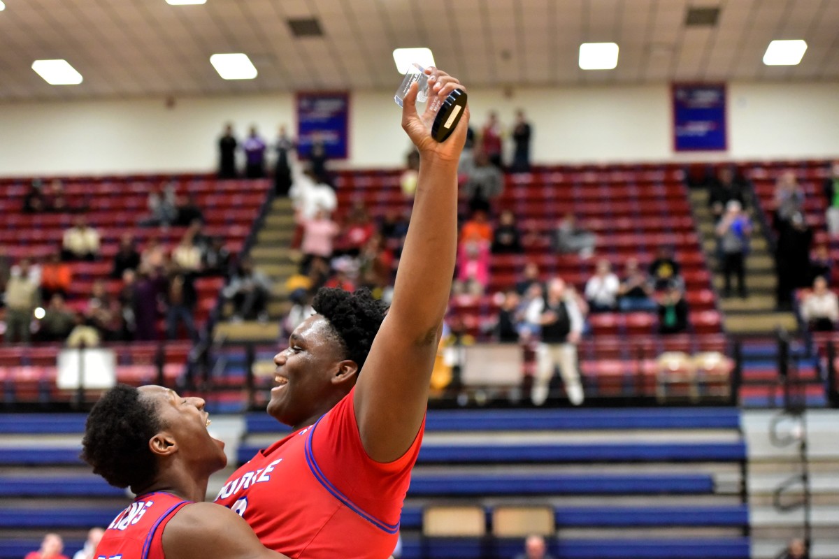 Moore's Ebi Bortey (right) celebrates after being named MVP following the Lions' win against Midwest City Carl Albert for the John Nobles Invitational title Jan. 20, 2024.